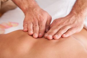 Beautiful young woman getting back massage